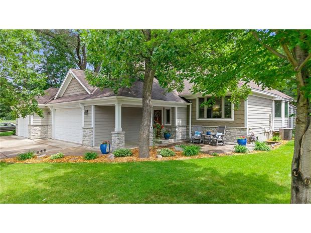 Front of the home with mature landscaping