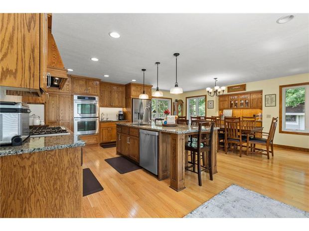 Kitchen with custom cabinets, granite, and the island