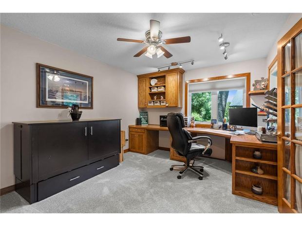 Office with built in desk and cabinetry