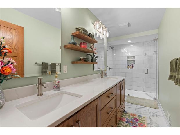 Bathroom with double vanity and walk-in shower