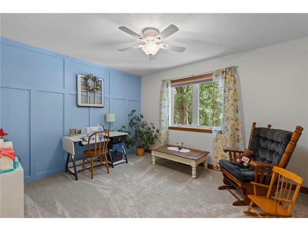 A room with board and batten and a window on the trees