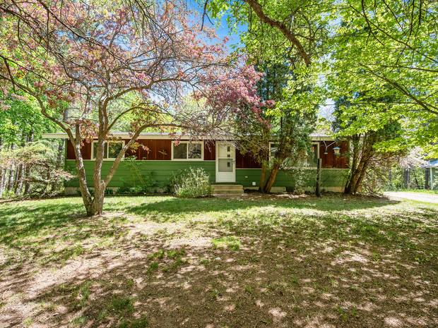 The home set back among mature trees