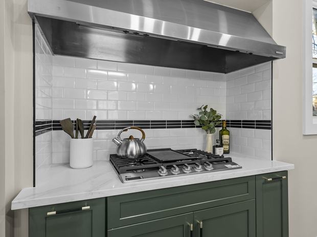 Gas cooktop with tile surround and range hood