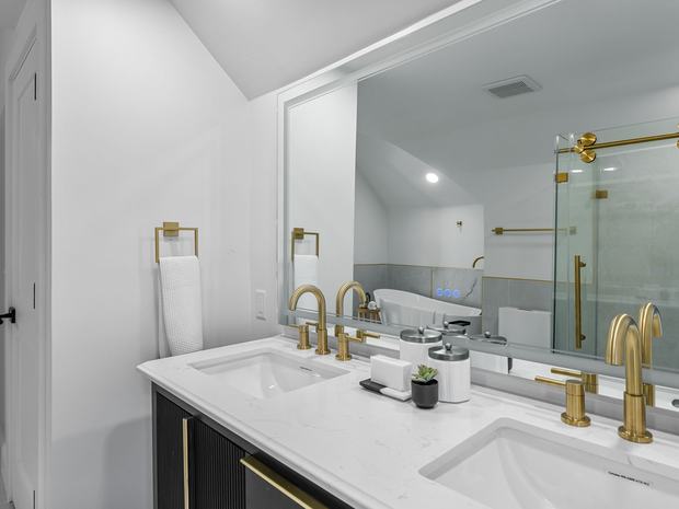 Double vanity and glass shower in the primary bath