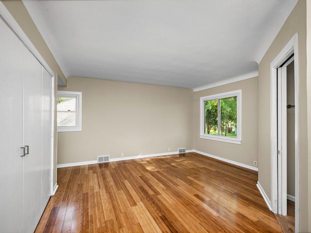 Main level bedroom with restored hardwood