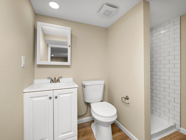 Lower level bathroom with a subway tiled shower