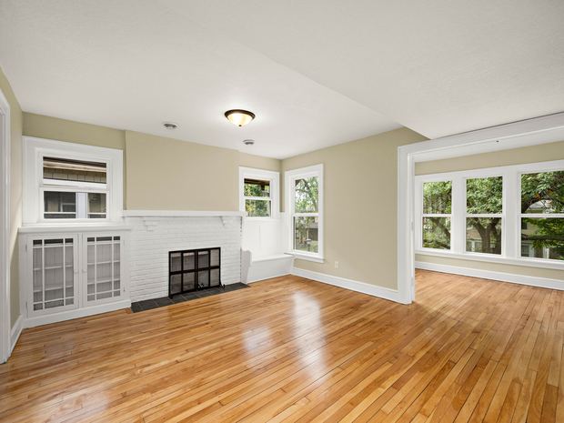 Upper unit living room with its fireplace and built in cabinets