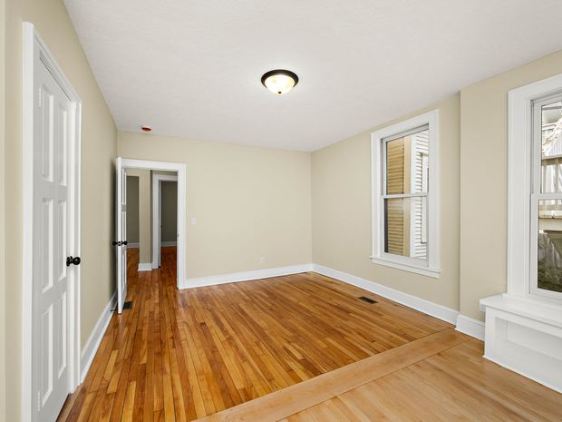 A lower unit bedroom with original hardwood