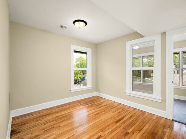 Upper unit bedroom with original hardwood
